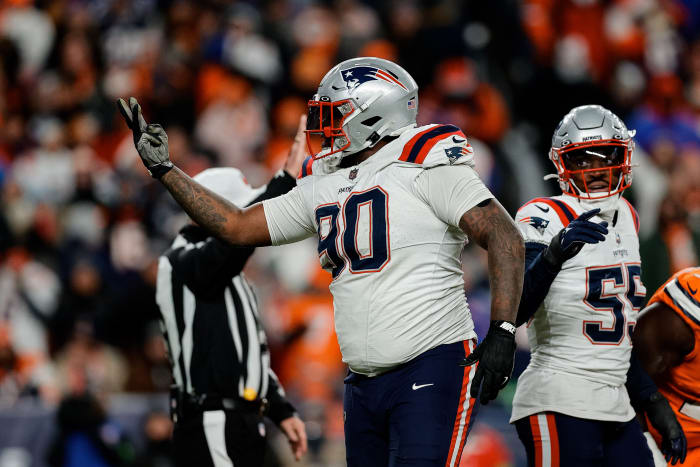 New England Patriots defensive tackle Christian Barmore (90) reacts after a play ]in the third quarter against the Denver Broncos at Empower Field at Mile High.